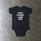 Cute Is What I Aim For onesie in black, laid flat