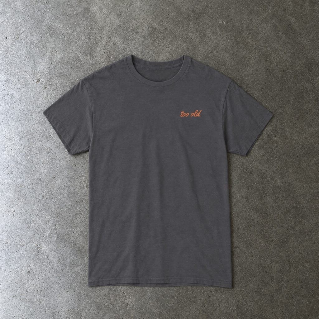 I'm Too Old For This Pit Danny Tee in charcoal, laid flat