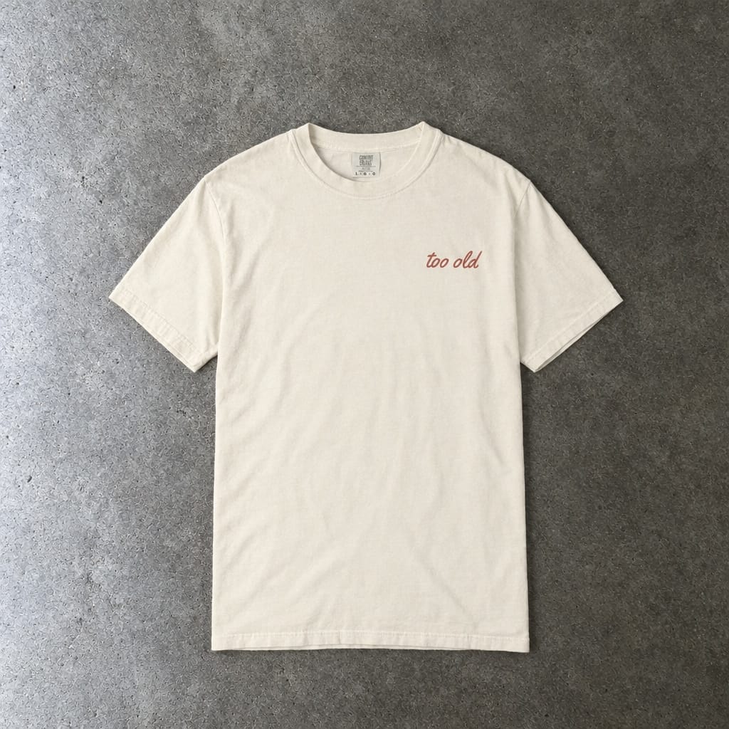 I'm Too Old For This Pit Danny Tee on Comfort Colors in ivory, laid flat