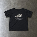Second Generation Pop-punk Kid 2.0 Baby Tee toddler tee in black, laid flat
