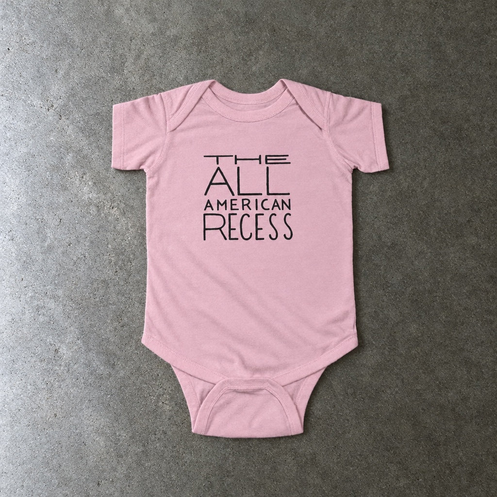 The All-American Recess onesie in pink, laid flat